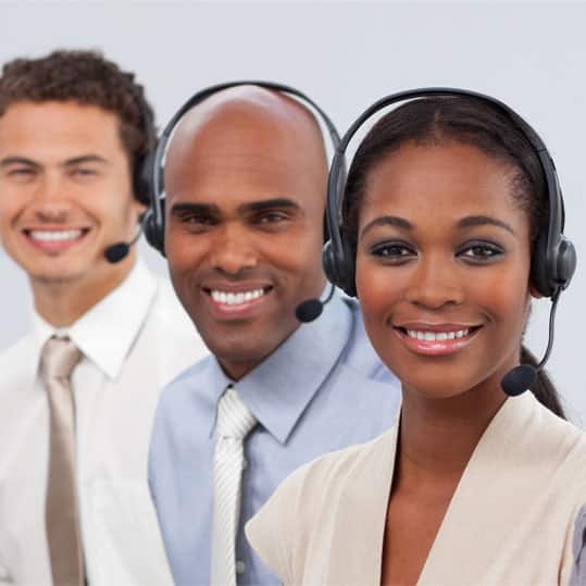 Variety of people with headsets on working in a call center agency.