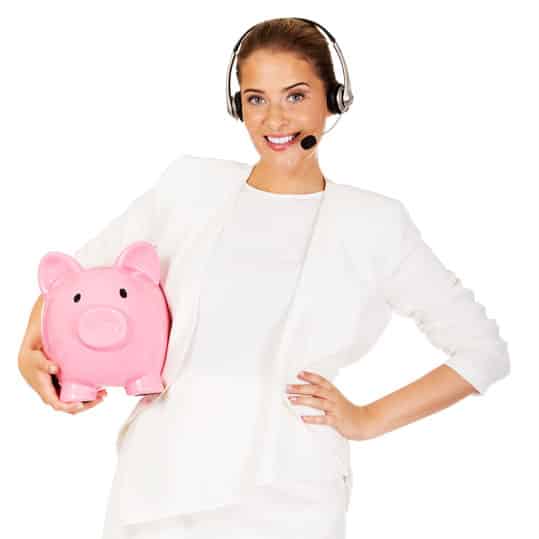 Young businesswoman wearing a headset holding a piggy bank.